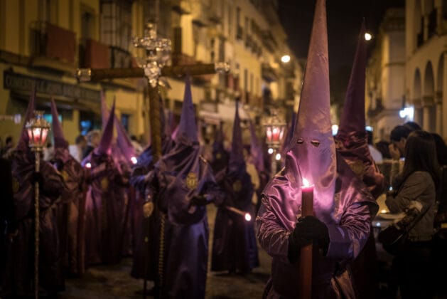 Crowd in costumes in semana santa festival captured in seville